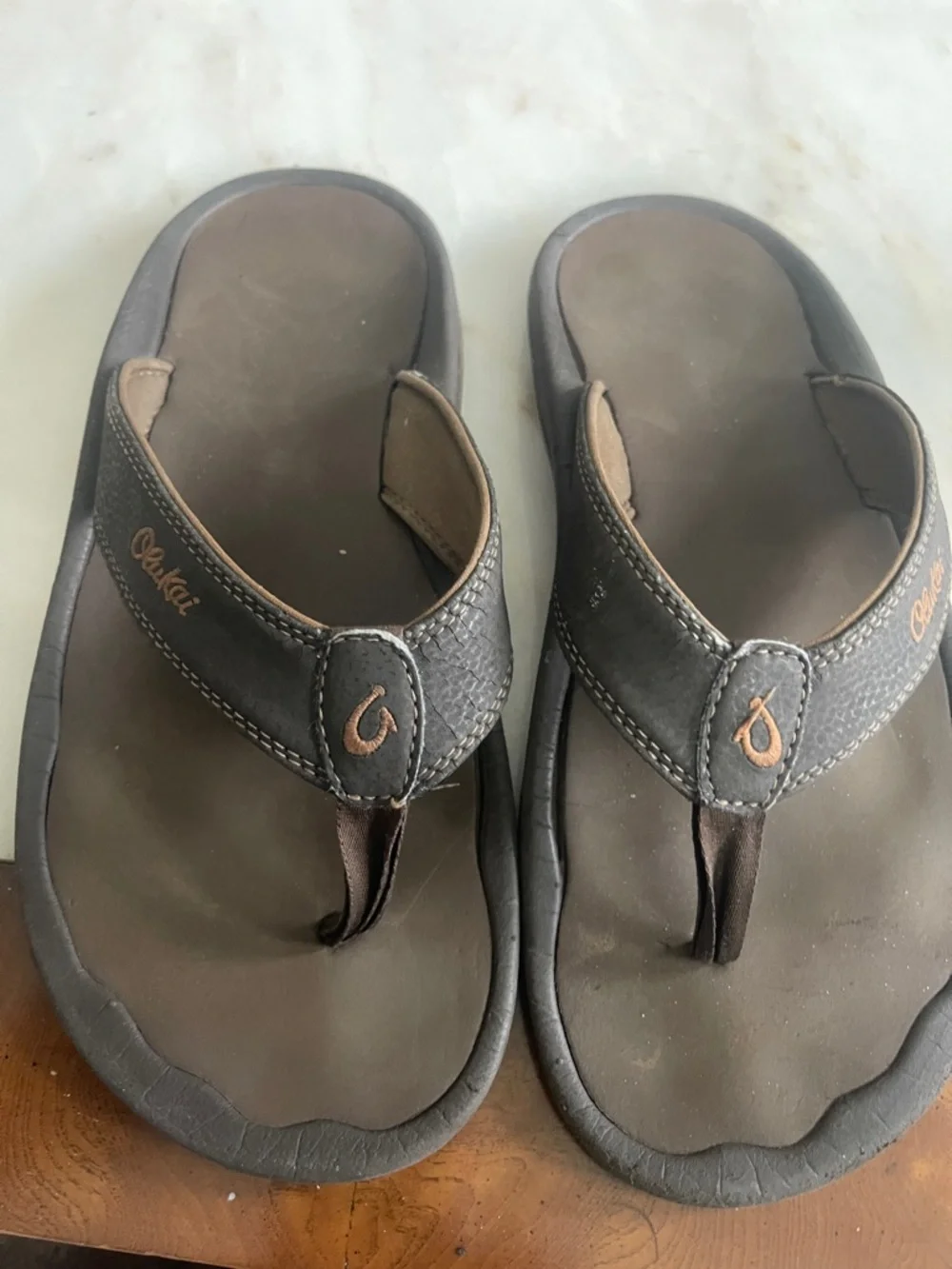 OluKai Dark Brown Leather Thong Sandals with Tan Stitching
